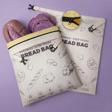Purple reusable beeswax bread bags with bread pattern for eco-friendly kitchen storage