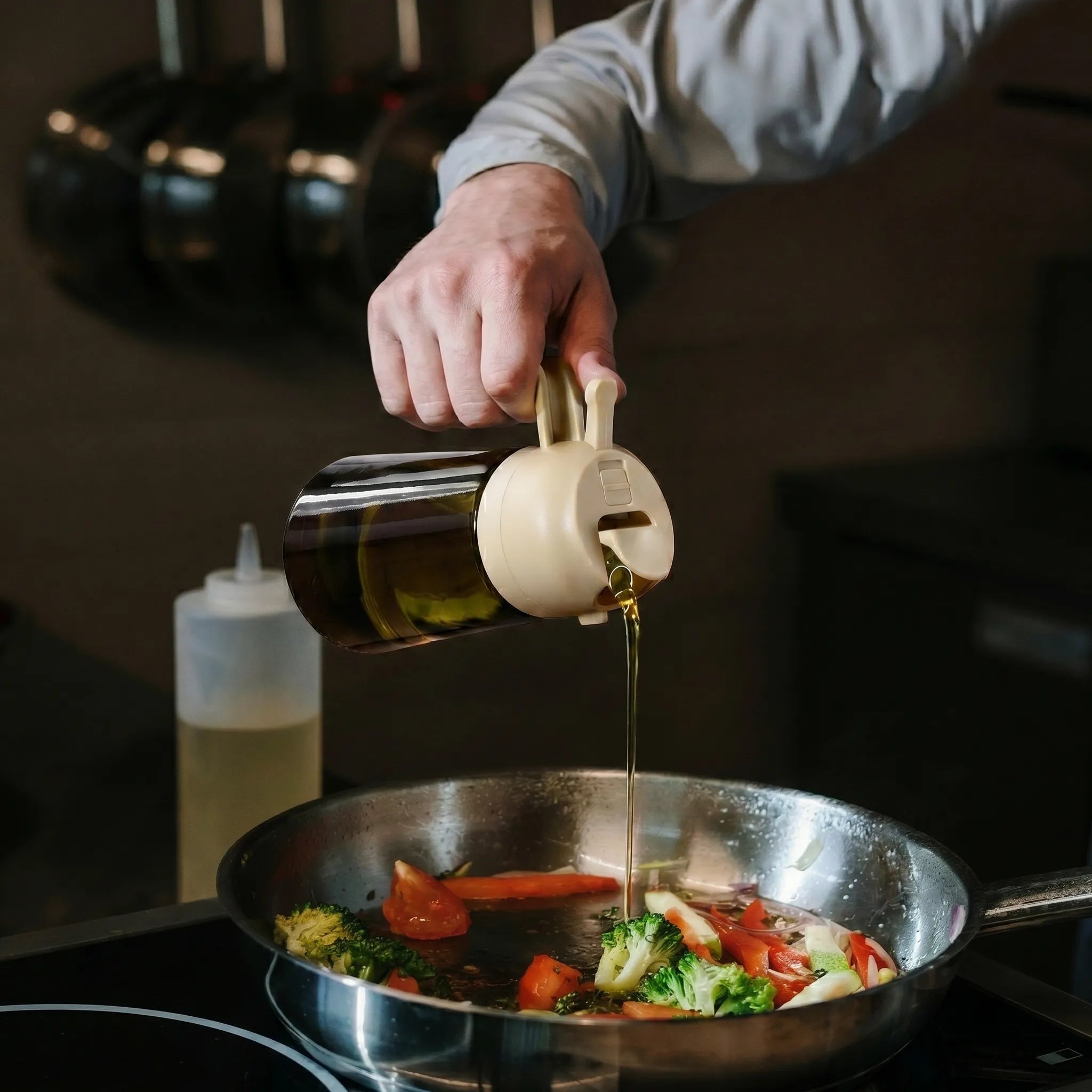 use oil bottle to pour oil into the pan