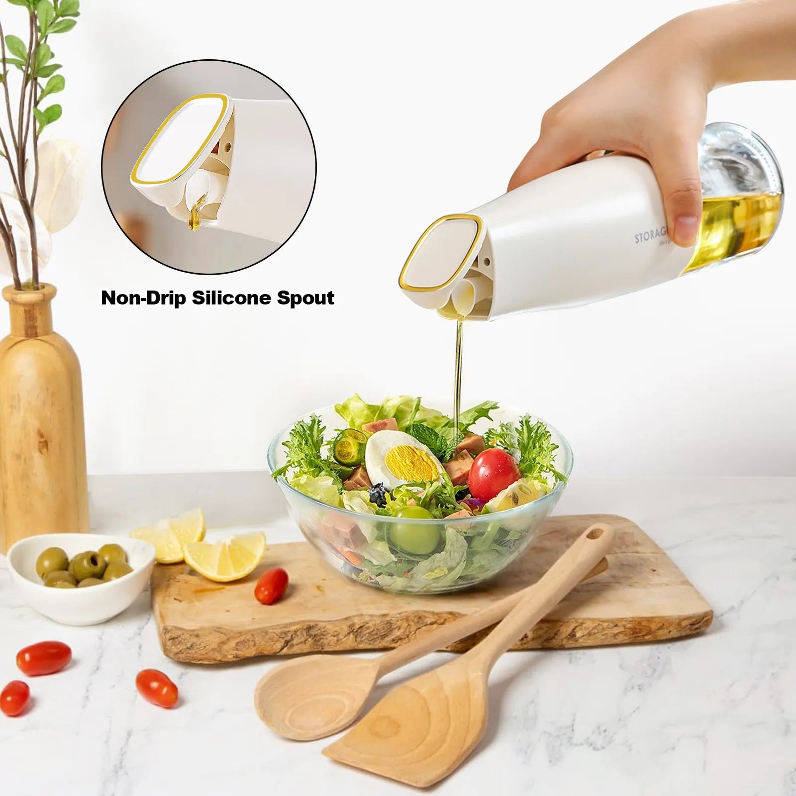 Hand pouring oil over a fresh salad using a white oil dispenser pourer