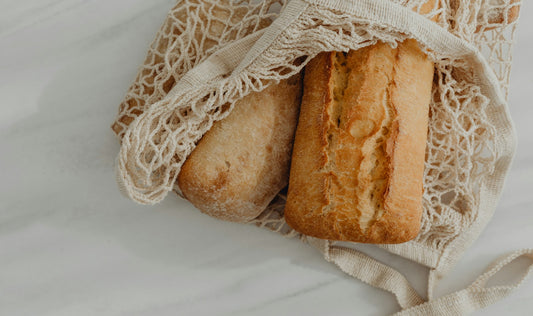 Basket of fresh artisan bread on a kitchen counter for homemade bread storage