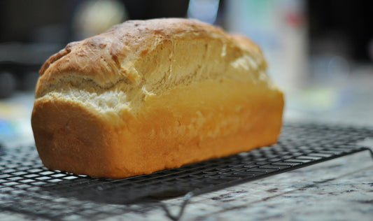 Fresh homemade bread on a cooling rack before slicing and freezing