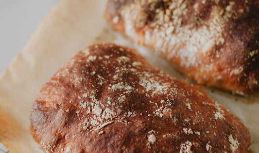 Two crusty loaves cooling on a rack for crisp-crust bread storage