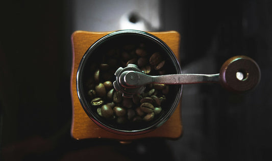 Coffee grinder filled with beans illustrating a low-retention grinding workflow