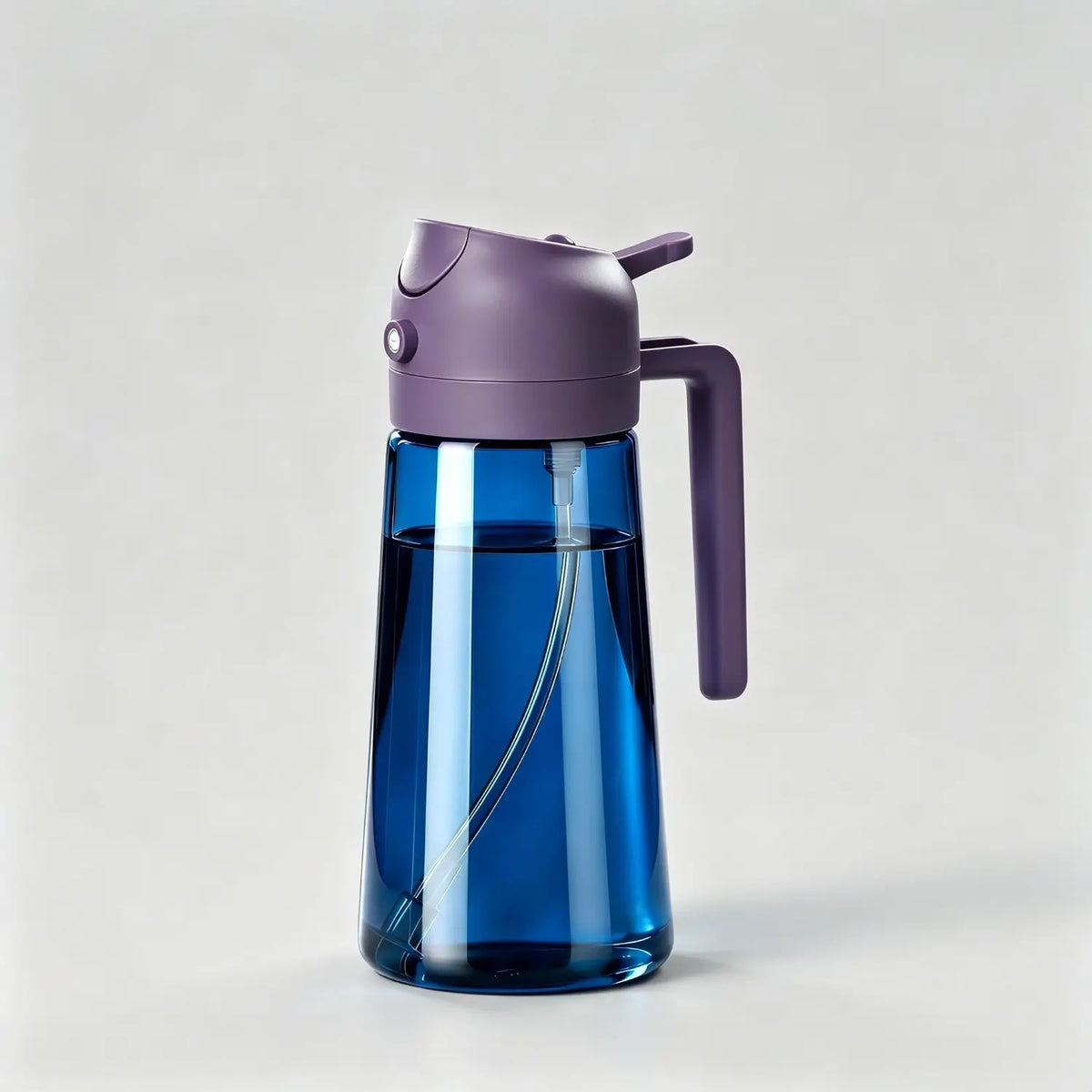 Blue glass oil dispenser bottle with purple lid and handle for kitchen cooking on light grey background
