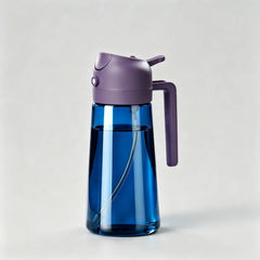 Blue glass oil dispenser bottle with purple lid and handle for kitchen cooking on light grey background