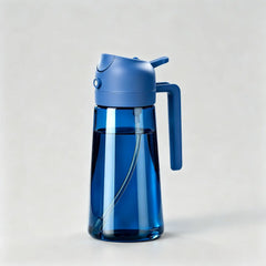 Blue glass oil dispenser bottle with Blue lid and handle for kitchen cooking on light grey background