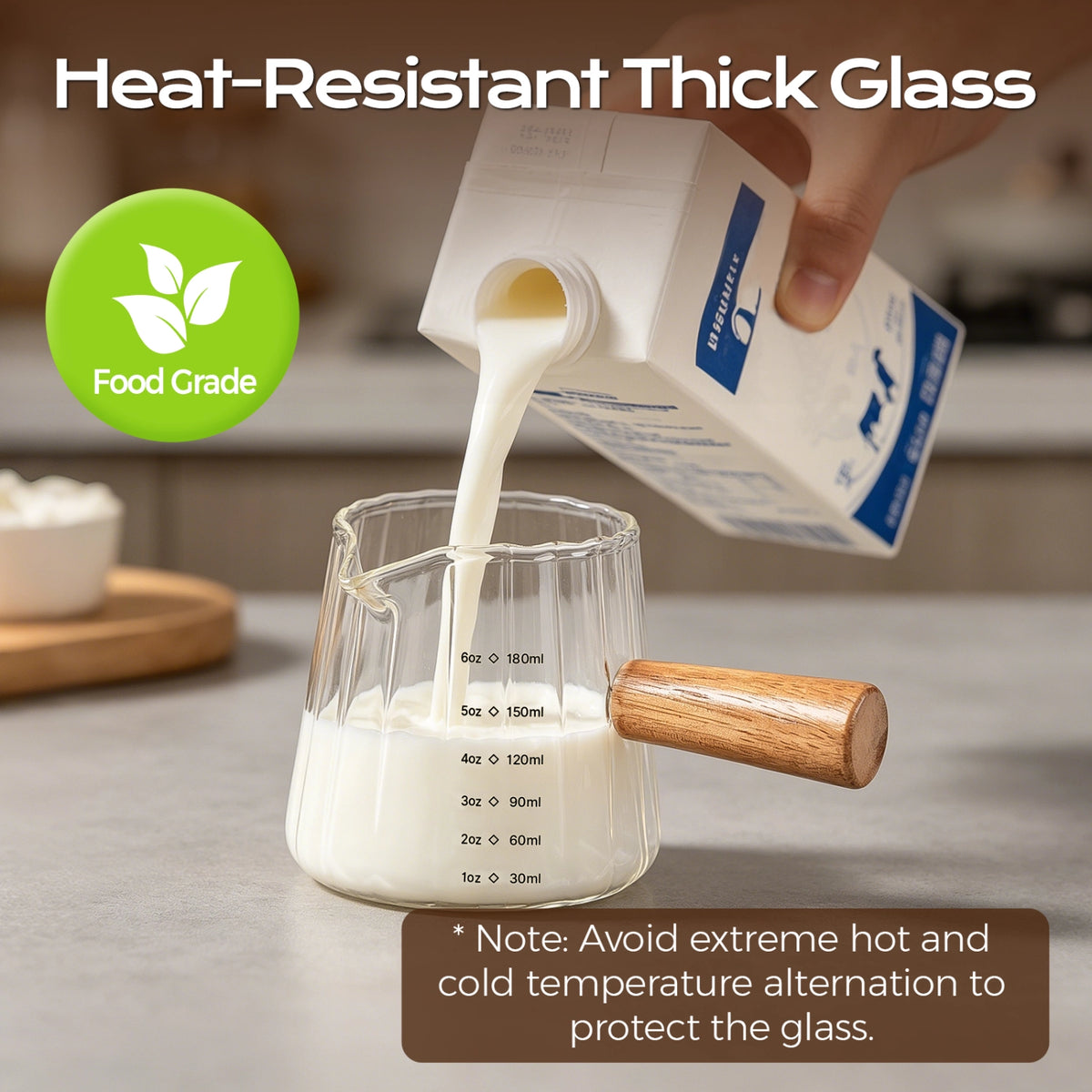 Milk poured from a carton into a fluted glass measuring pitcher with a wooden handle.