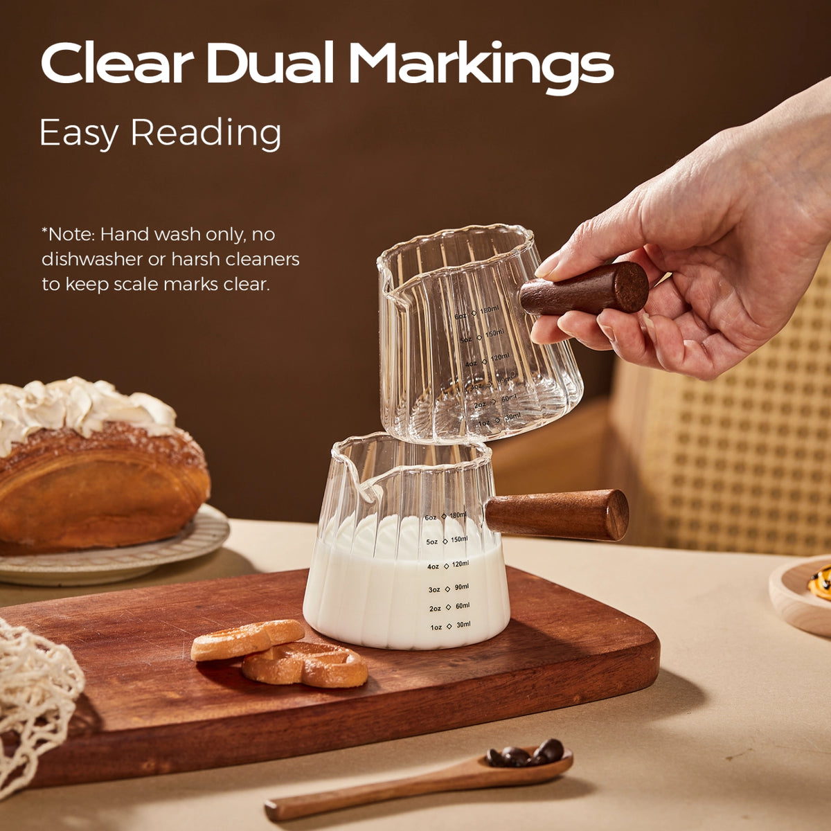 Fluted glass pitchers with wooden handles showing milliliter and ounce measurement markings.
