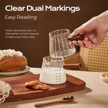 Fluted glass pitchers with wooden handles showing milliliter and ounce measurement markings.