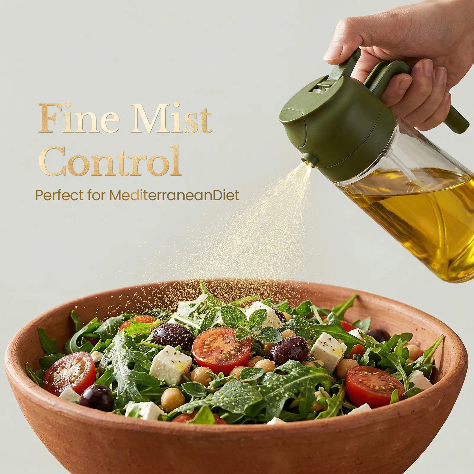Hand using a glass oil sprayer bottle for healthy salad dressing preparation