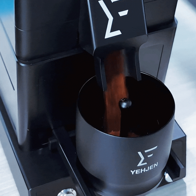 A close-up of a premium espresso machine extracting rich espresso from fresh grounds of a 98mm burr coffee grinder with zero retention