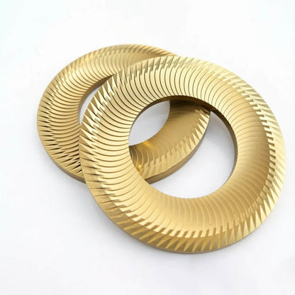 Close-up of golden flat burrs replacement parts for high-end espresso coffee grinders