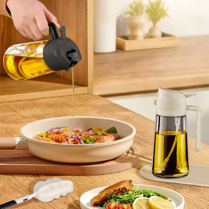 Black-lid oil dispenser pouring oil over pasta beside a white-lid glass oil sprayer.