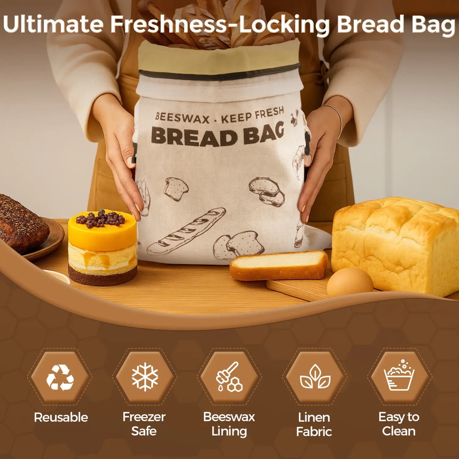 A person holding a reusable beeswax bread bag with the words KEEP FRESH and BREAD BAG printed on it, surrounded by various baked goods including a loaf of bread, a round cake, and pastries. The bag is designed for sustainable food storage..#Brown