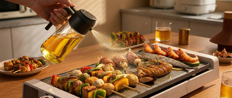 YARRAMATE oil sprayer spraying olive oil while grilling meat and vegetables, ideal for healthy cooking at home