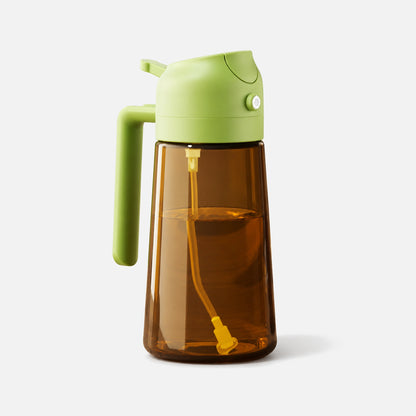 Dark brown glass 2-in-1 oil sprayer with a green spray head.