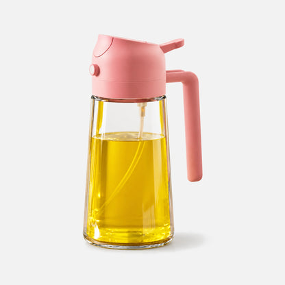 Clear glass 2-in-1 oil sprayer with a pink spray head.