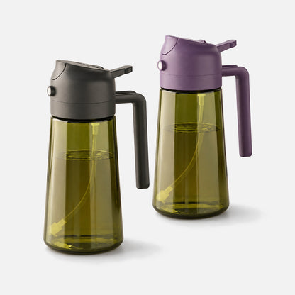 Two dark green glass oil sprayers with black and purple spray heads.