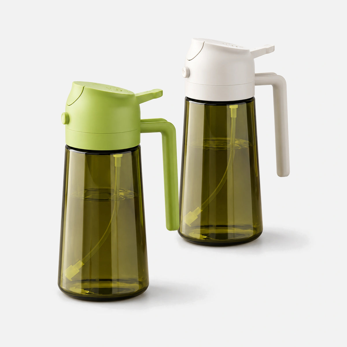 Two dark green glass oil sprayers with white and green spray heads.