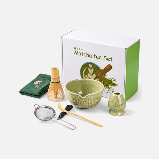 Matcha set with green bowl, bamboo whisk and accessories.