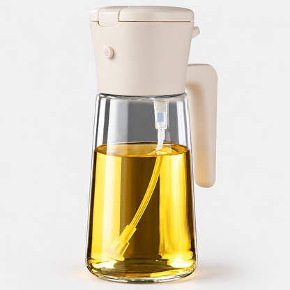 White 470mL glass oil sprayer and pour dispenser on a light gray background; oil shown for demonstration.