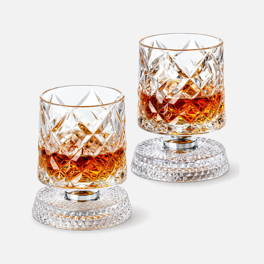 Two whiskey glasses with rotating bases.